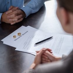 partial-view-of-couple-at-table-with-divorce-documents.jpg